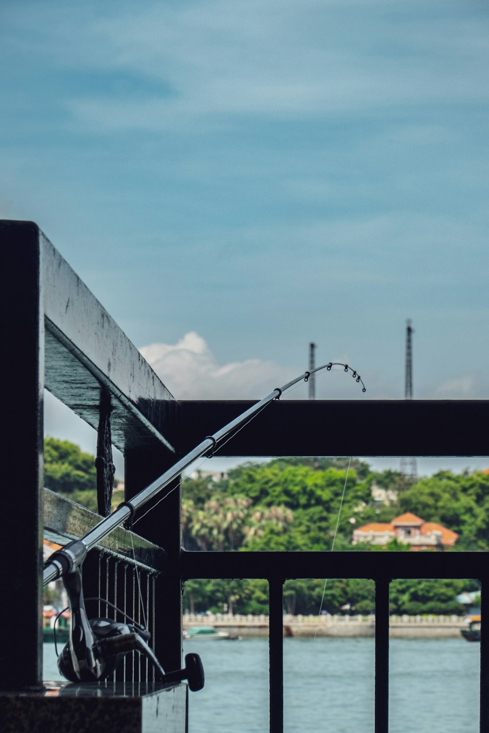 black fishing rod near railings