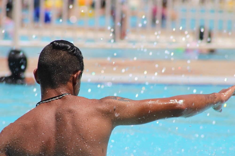 topless man on swimming pool