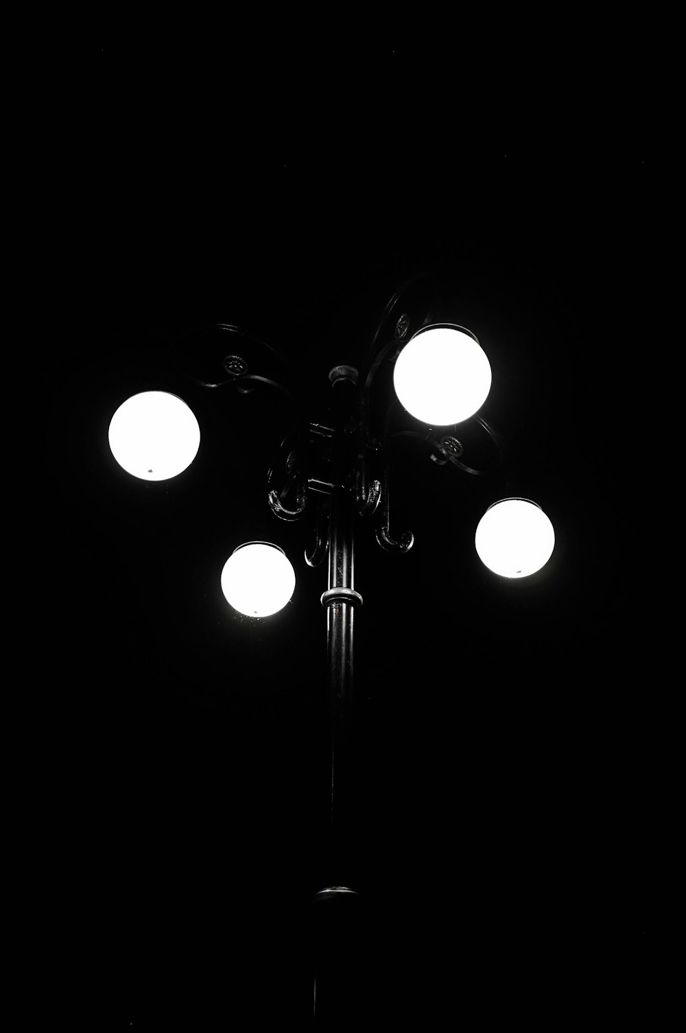 grayscale photography of lighted lamp post