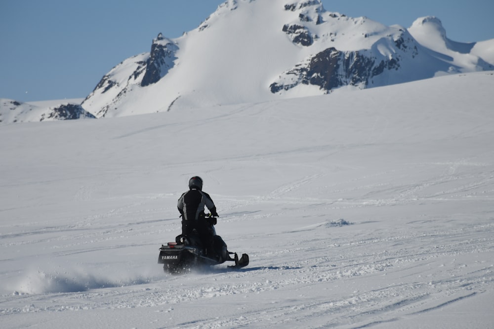 person riding snowmobile