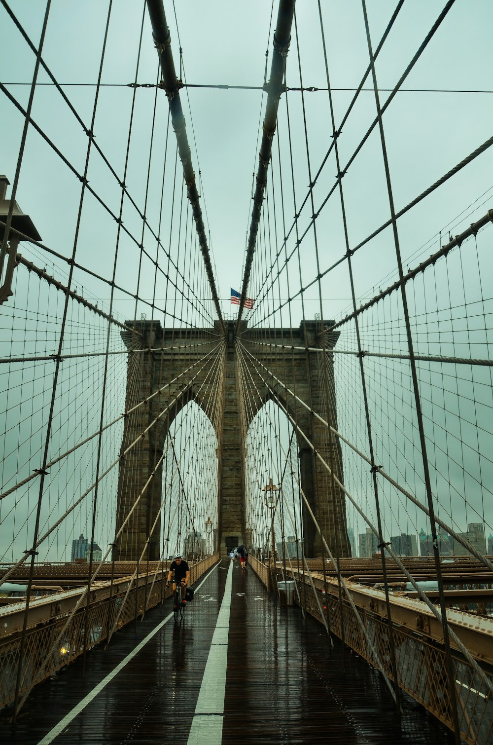 man riding bike on bridge