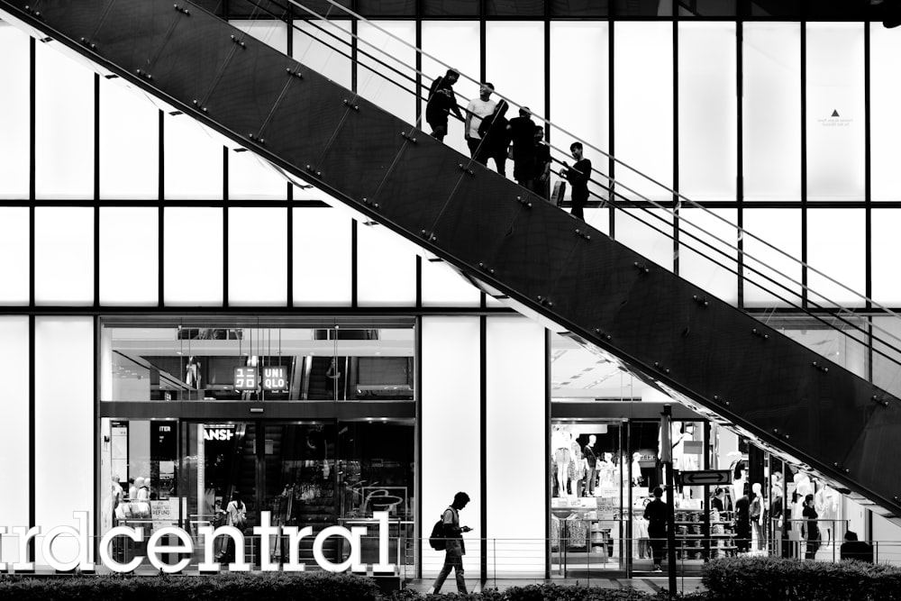 a group of people walking up and down a stair case