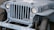 A vintage military jeep painted in grey-blue featuring a prominent white star on the hood. The vehicle has a distinctive grille with vertical slots, round headlights, and a visible license plate marked with '427273 VR'. It is marked with 'U.S. NAVY 748891' on the side.