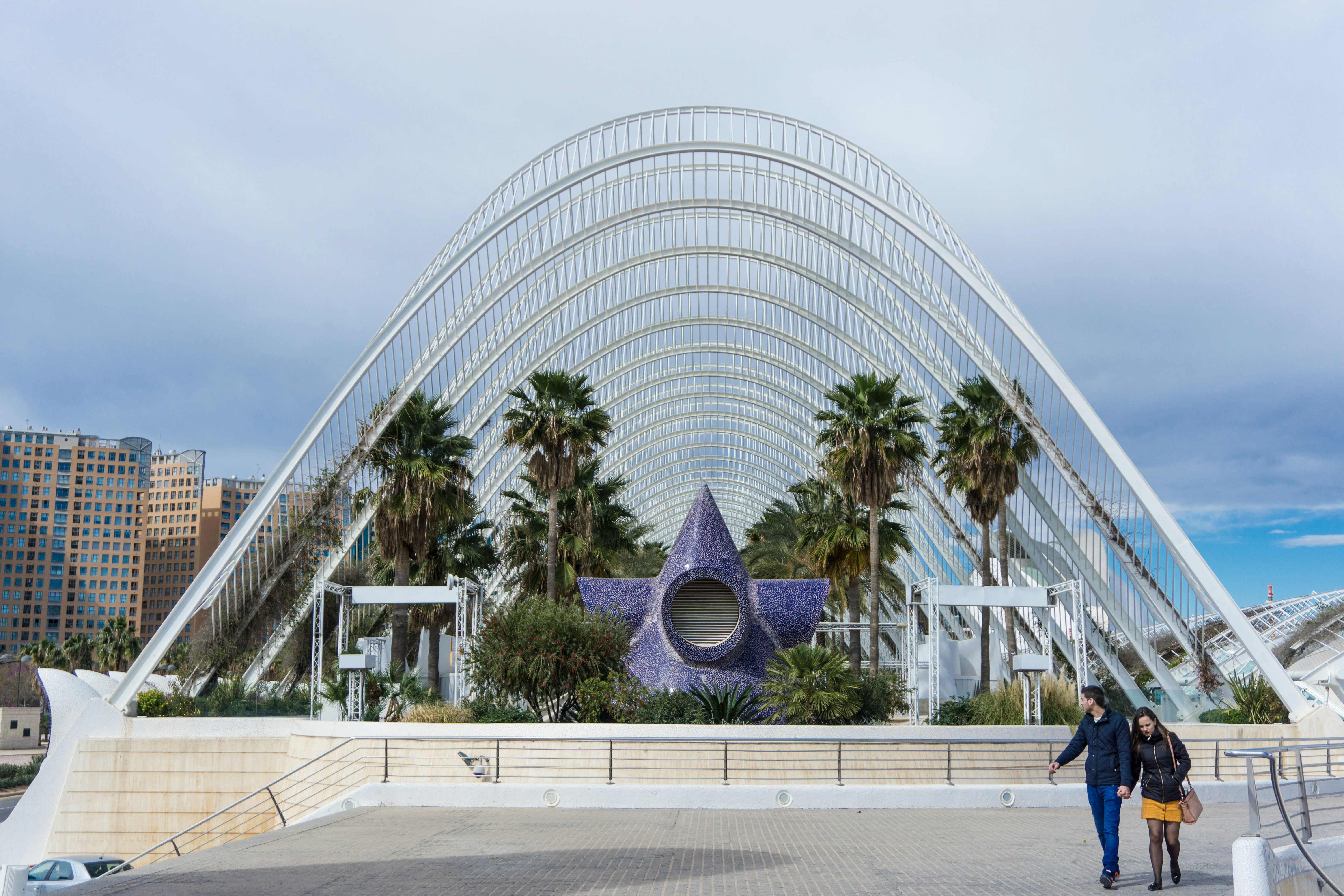 man and woman walking near structure