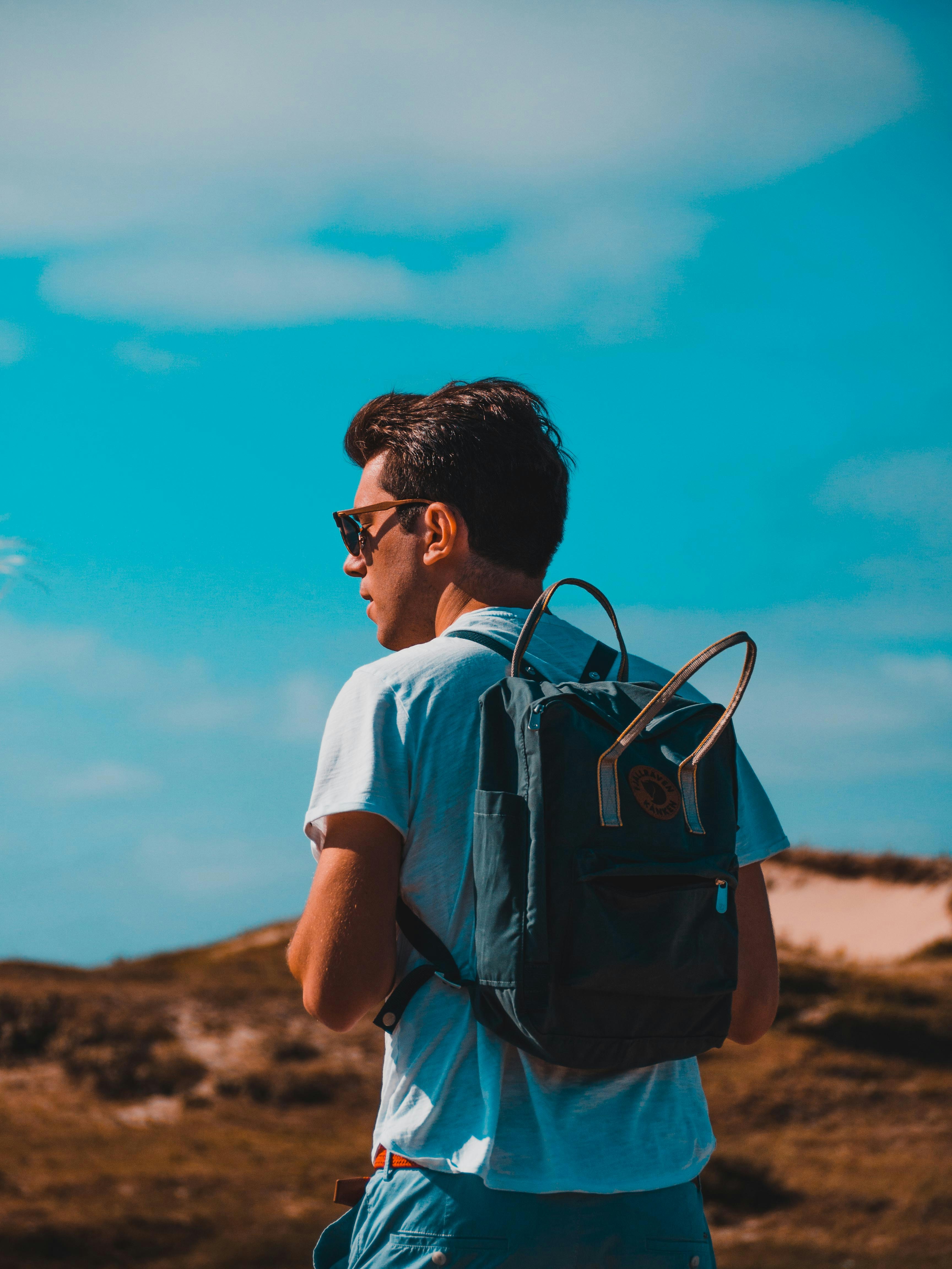 man wearing backpack during daytime