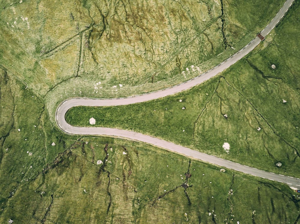 an aerial view of a winding road in the countryside