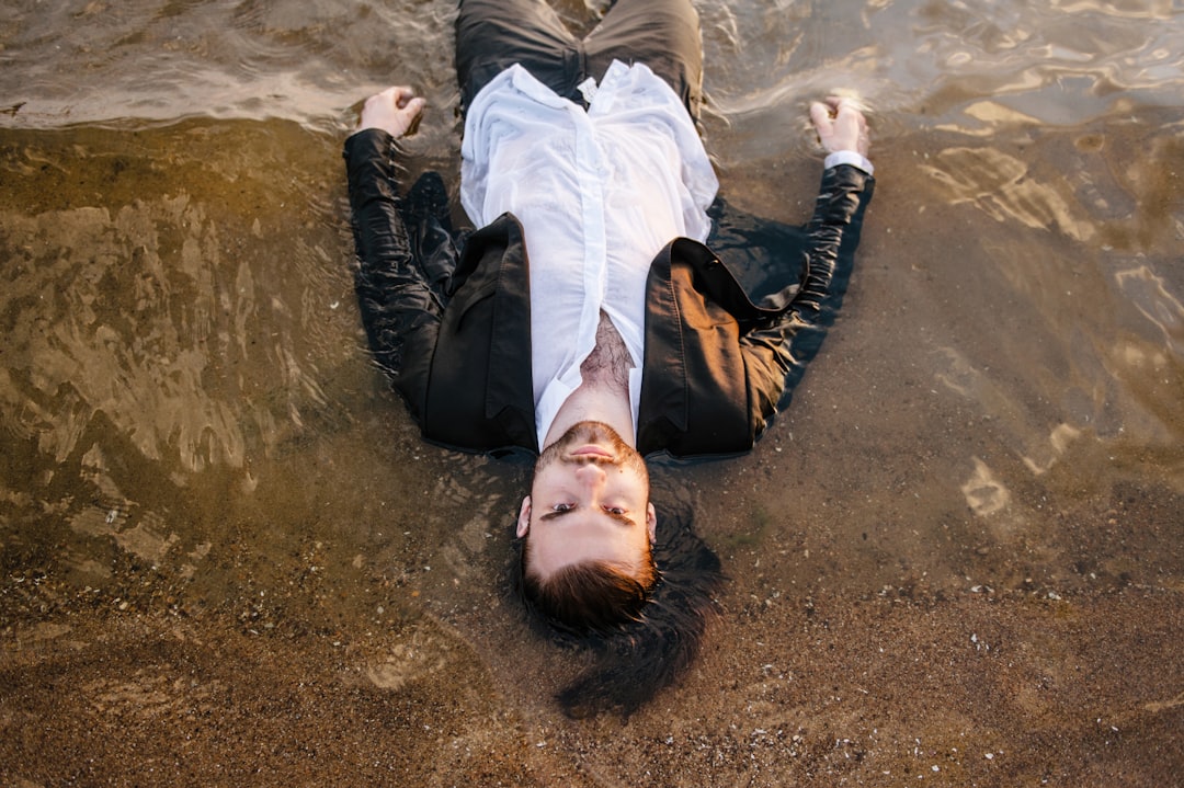 man lying on soil, introvert