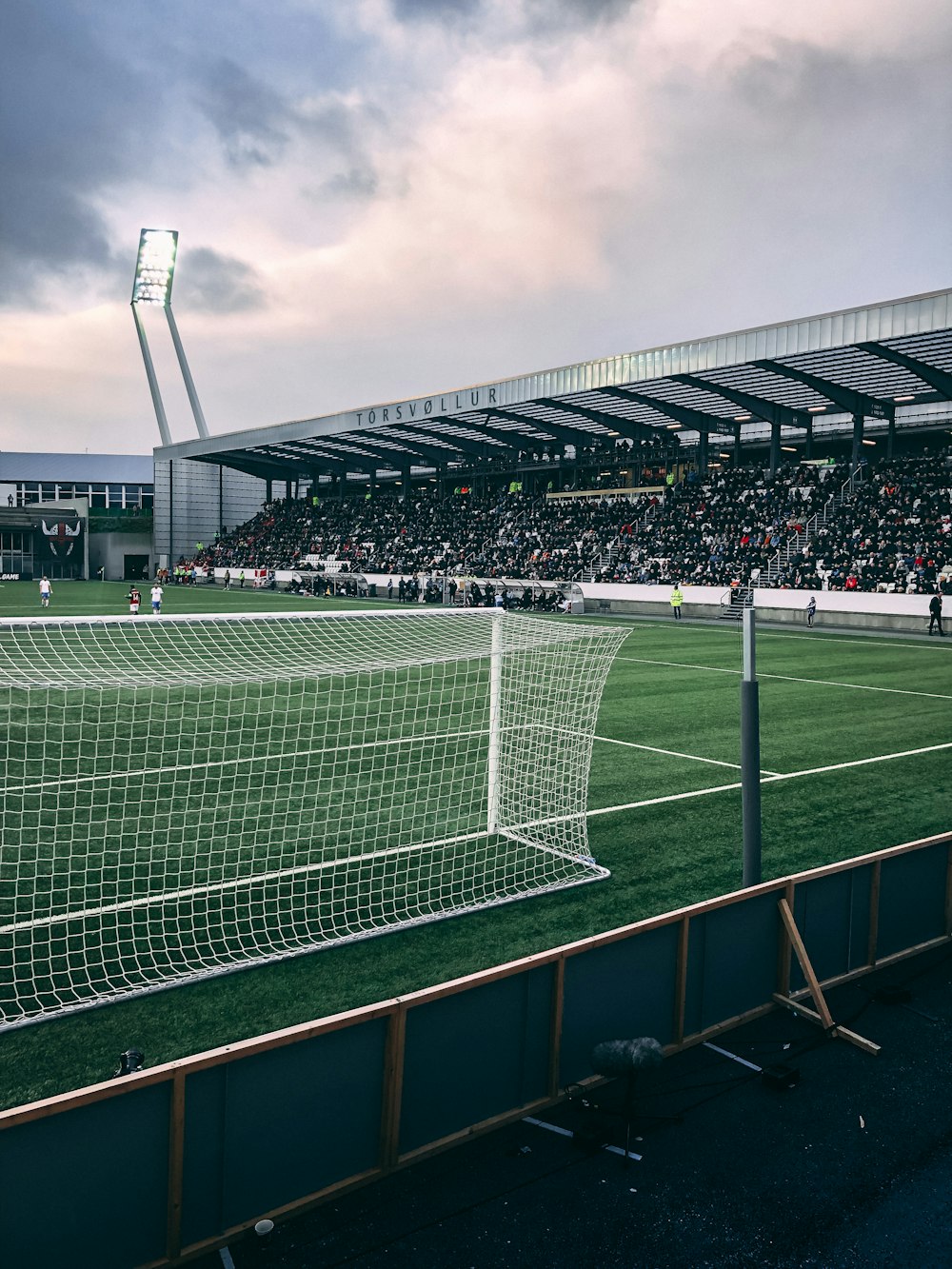 people watching soccer game under white and gray skies