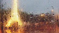 A calm window view showing a cityscape blurred by rain, evoking feelings of distance and introspection.