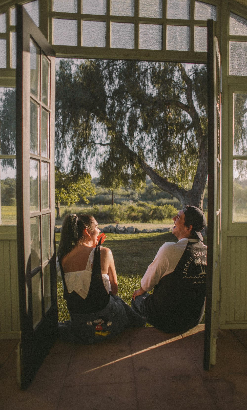 woman and man sitting near opened door