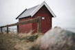 A weather-resistant wendy house used as a secure storage unit near the coast.