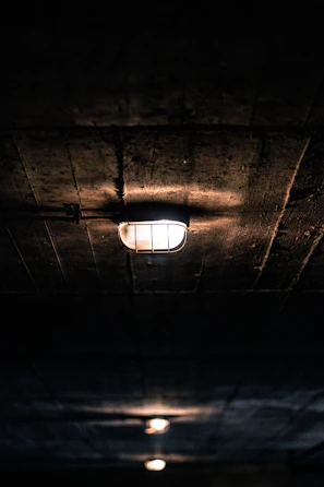 Country style wooden ceiling lamp illuminating a rustic kitchen space.