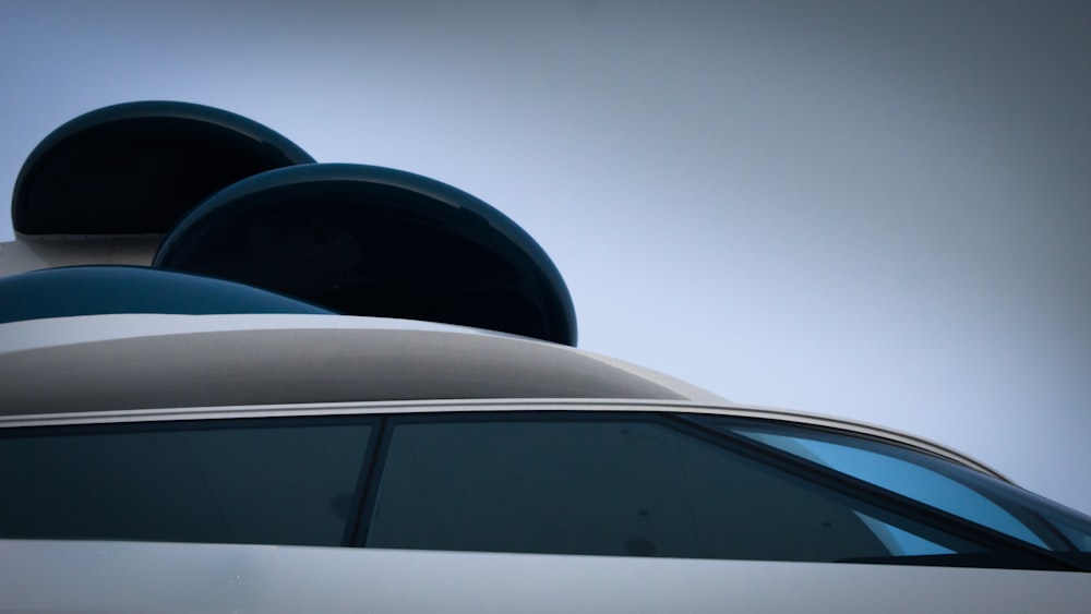 the roof of a white car with a sky background