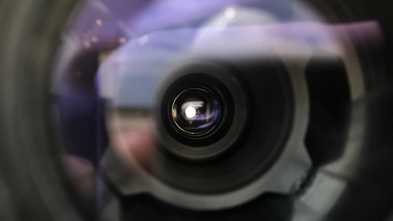 A close-up of a camera lens focused on a subject.