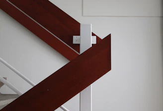 Image showing a newly installed staircase featuring rich wood treads and stylish black metal railings in a bright interior.