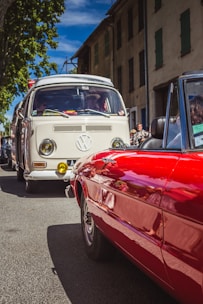A vibrant 1960s Volkswagen Transporter T1 parked at a sunny retro car meet