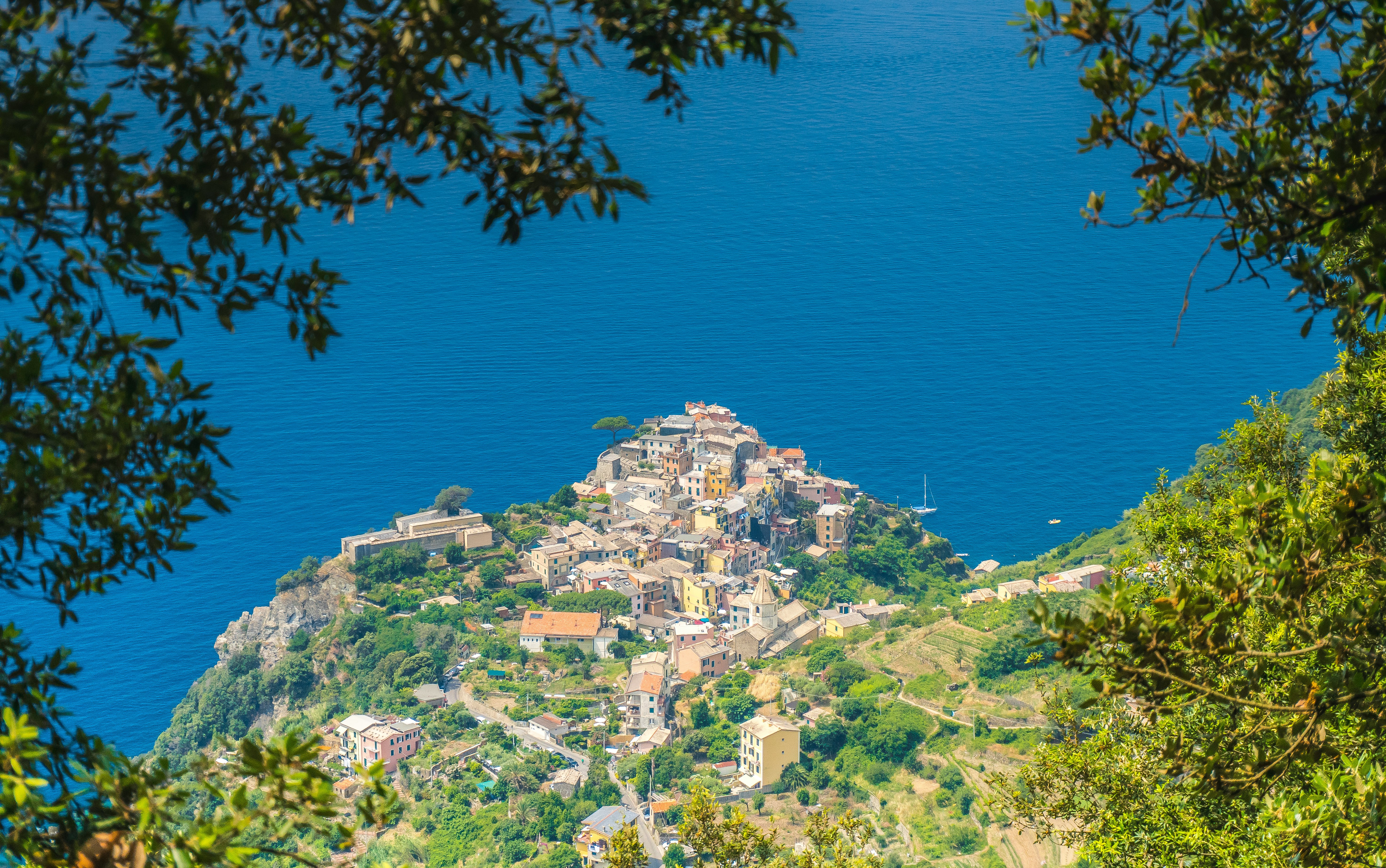 white building on top of mountain near ocean