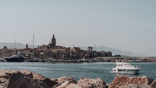 white yacht on body of water