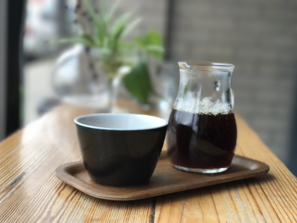 clear Turkish tea glass on wooden tray