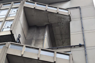 A detailed view of Wisma Equity's brutalist facade highlighting its architectural lines and urban presence.