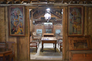 Intricately carved wooden furniture from the colonial era showcased in a warm, inviting room