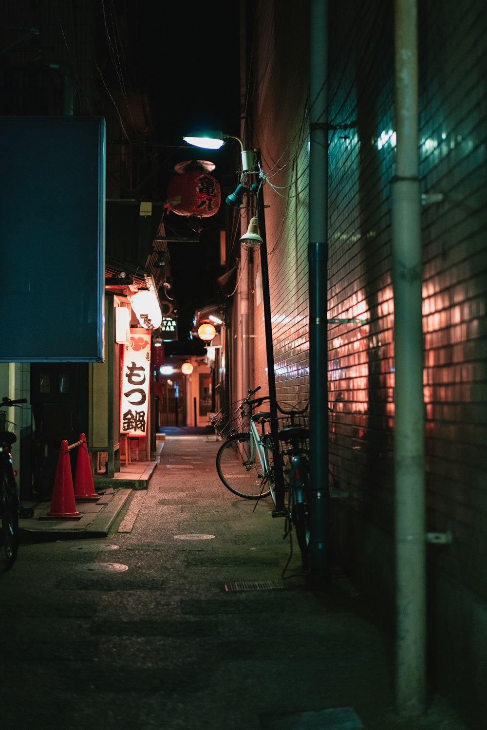 two bicycles on alley during night