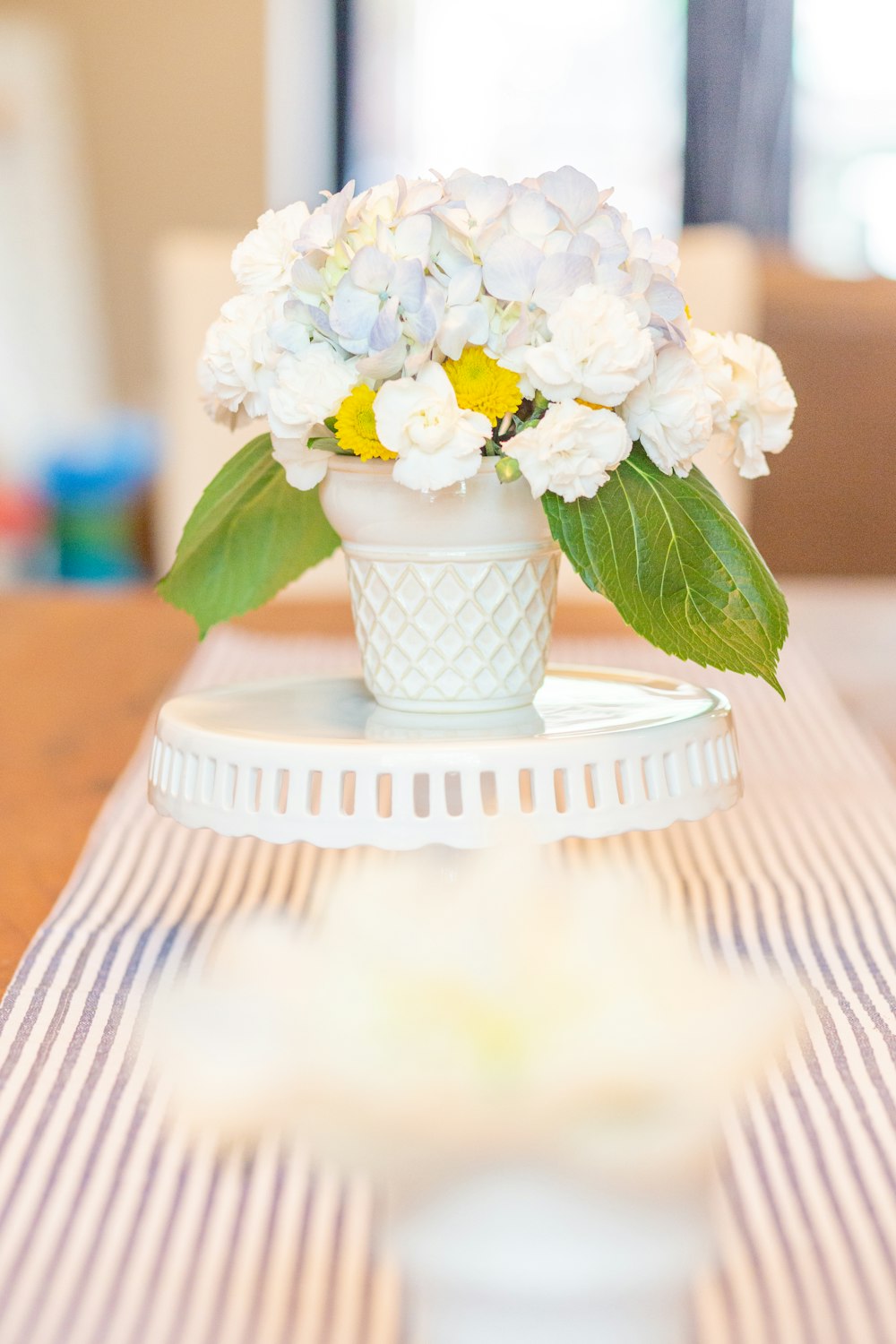 white petaled flower in white vase