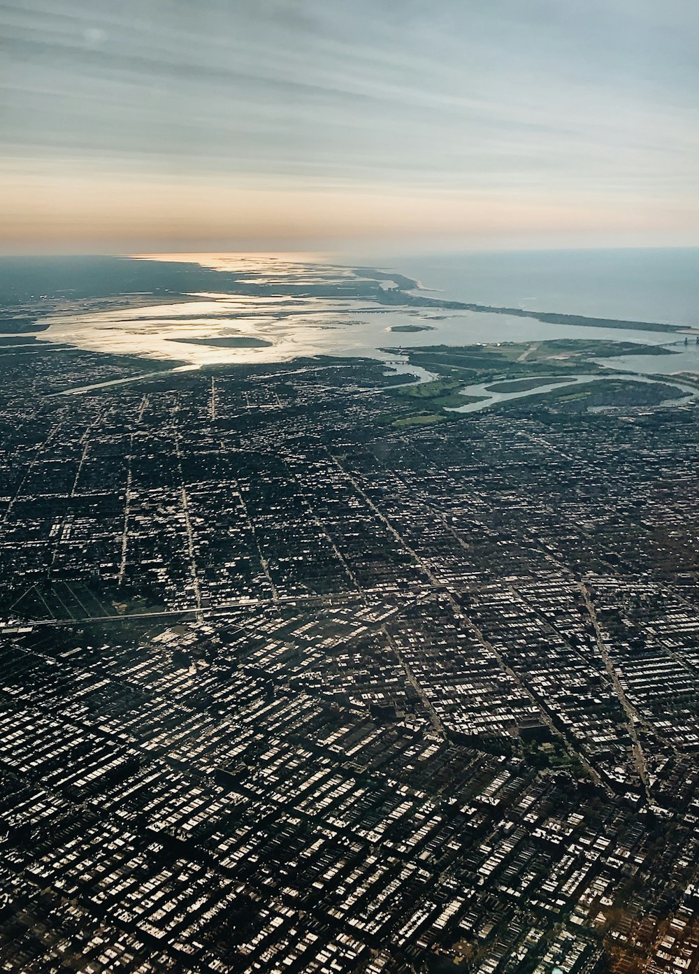 an aerial view of a city and a body of water