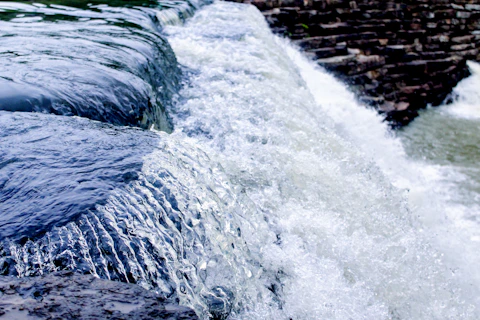 water flowing over rocks during daytime