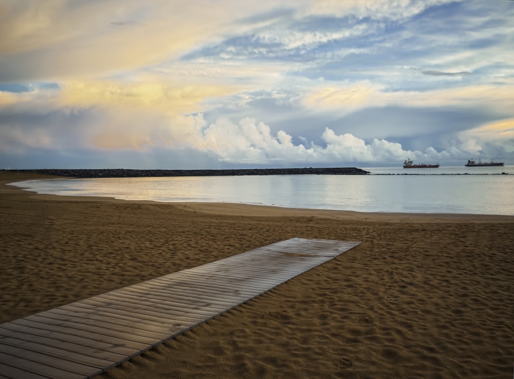 brown wooden dock on brown sand