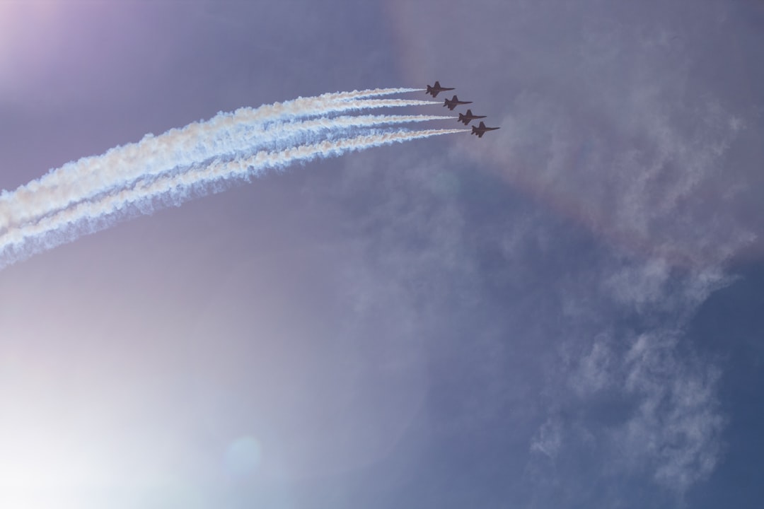 thee acrobatic jets on flight in formation with white smokes