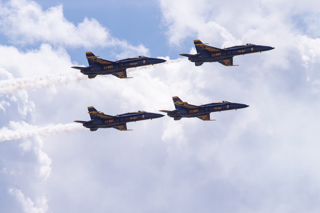 four blue fighter jet planes