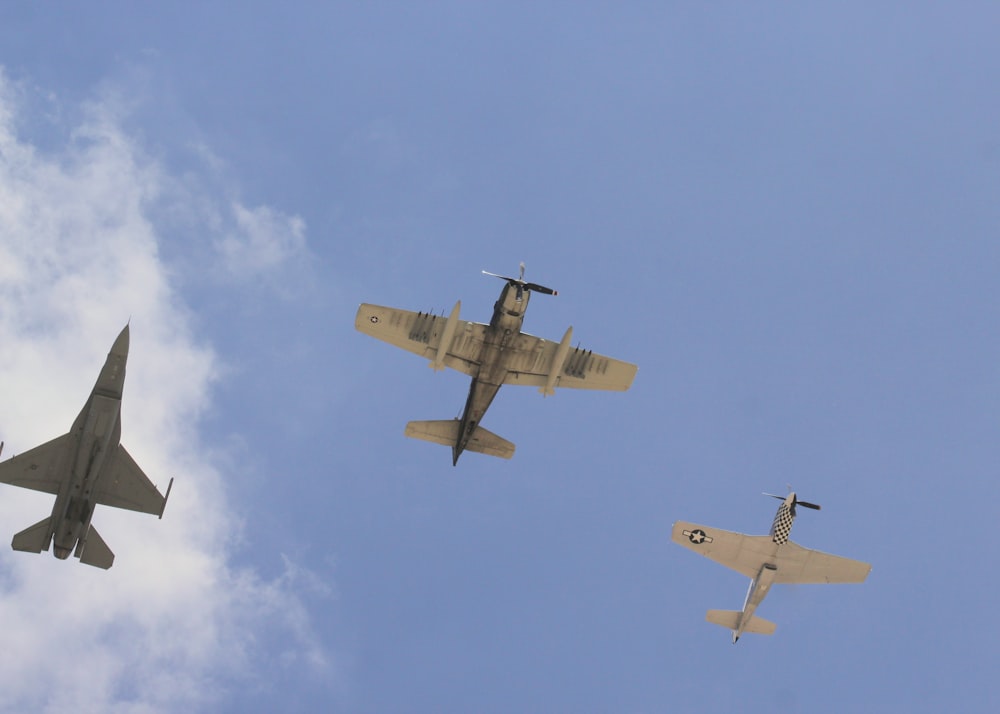 low angle photography of three different air planes on the sky