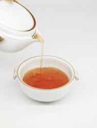 tea pours into white teacup