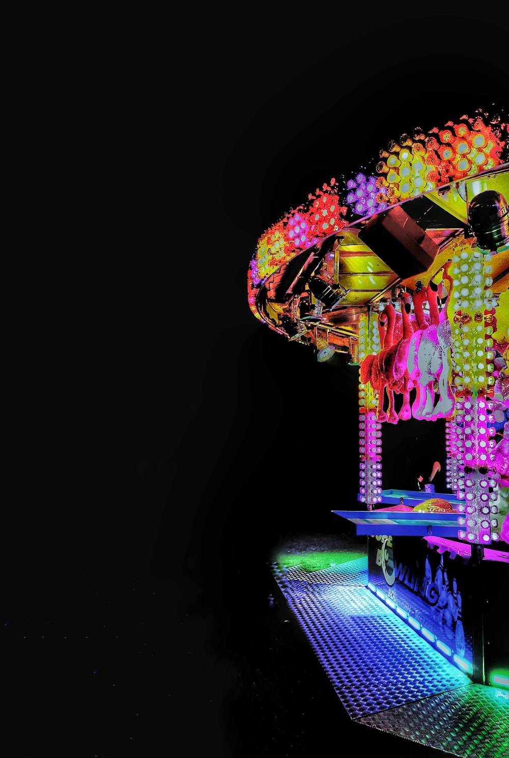 a brightly lit carnival ride in the dark
