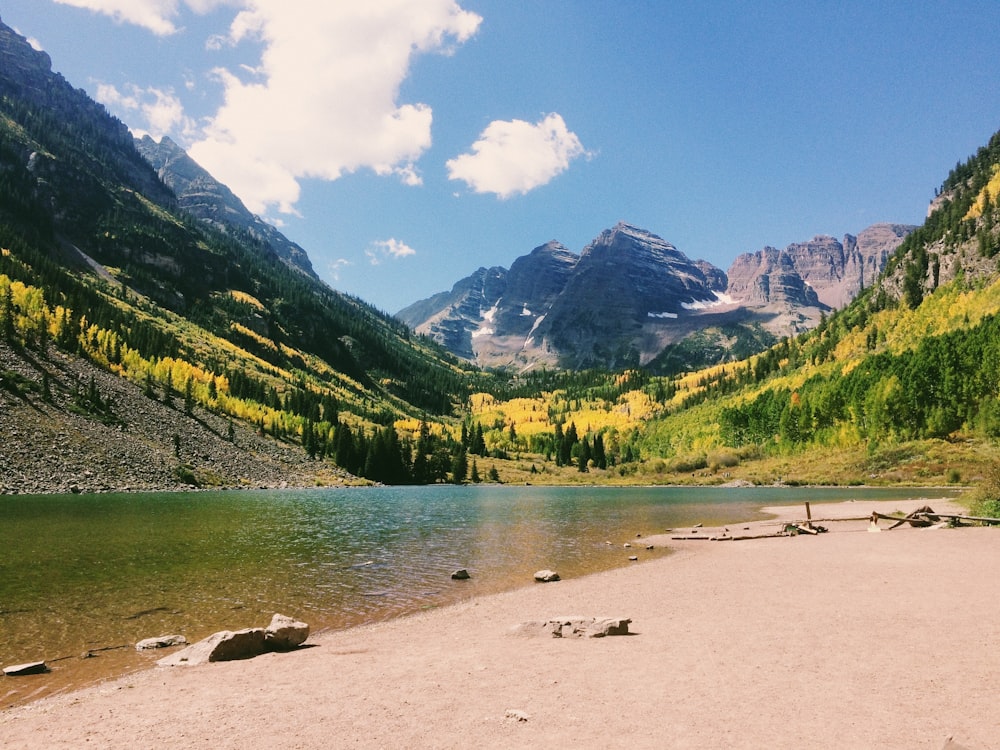 body of water on mountain slope during daytime