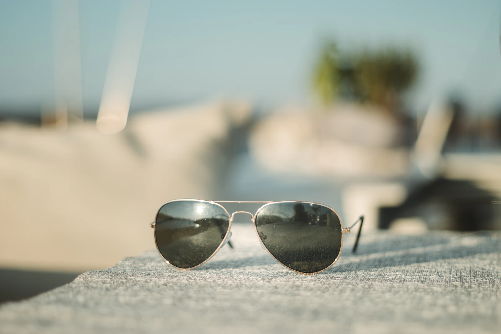 Aviator sunglasses on sand