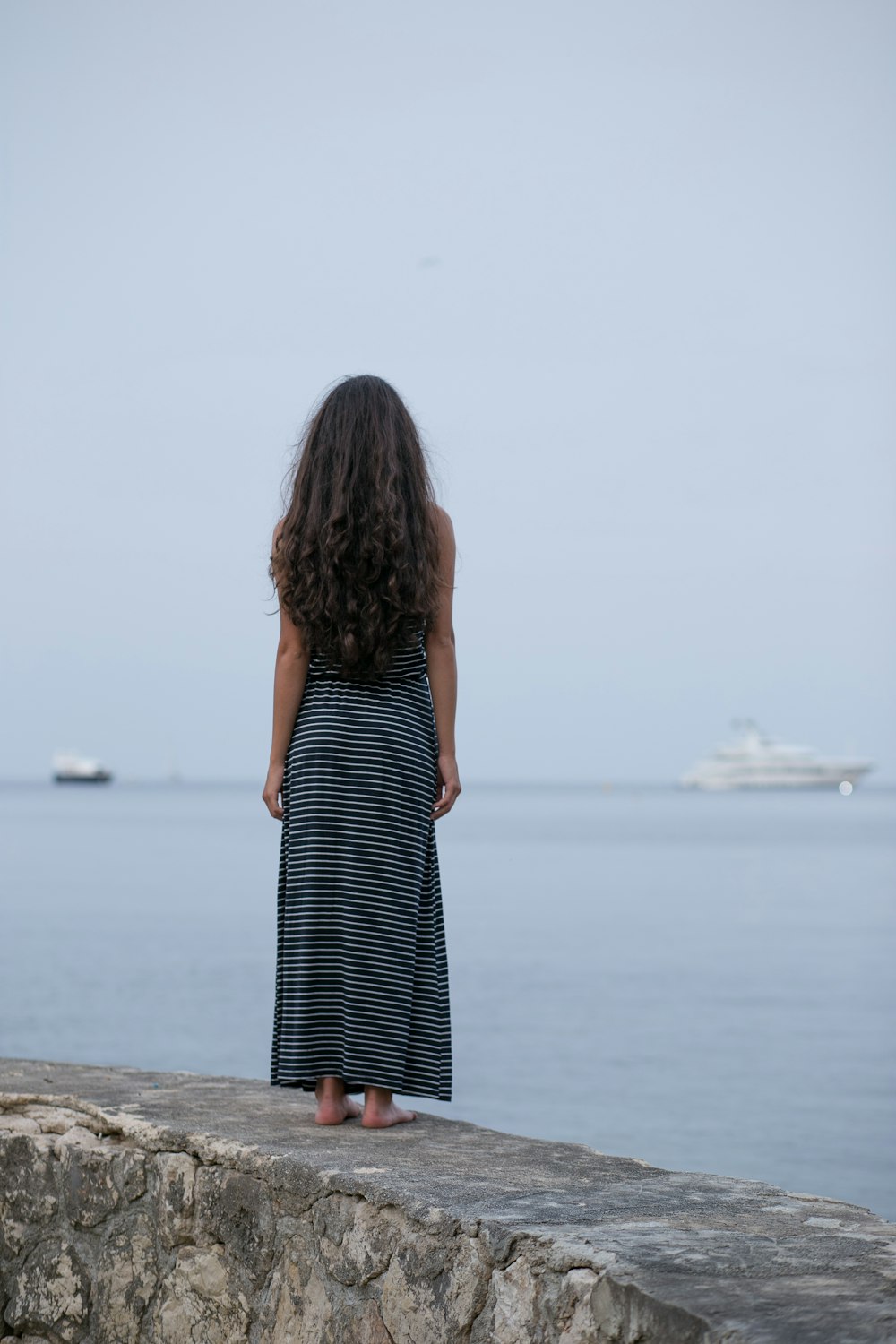 woman standing on gray pavement