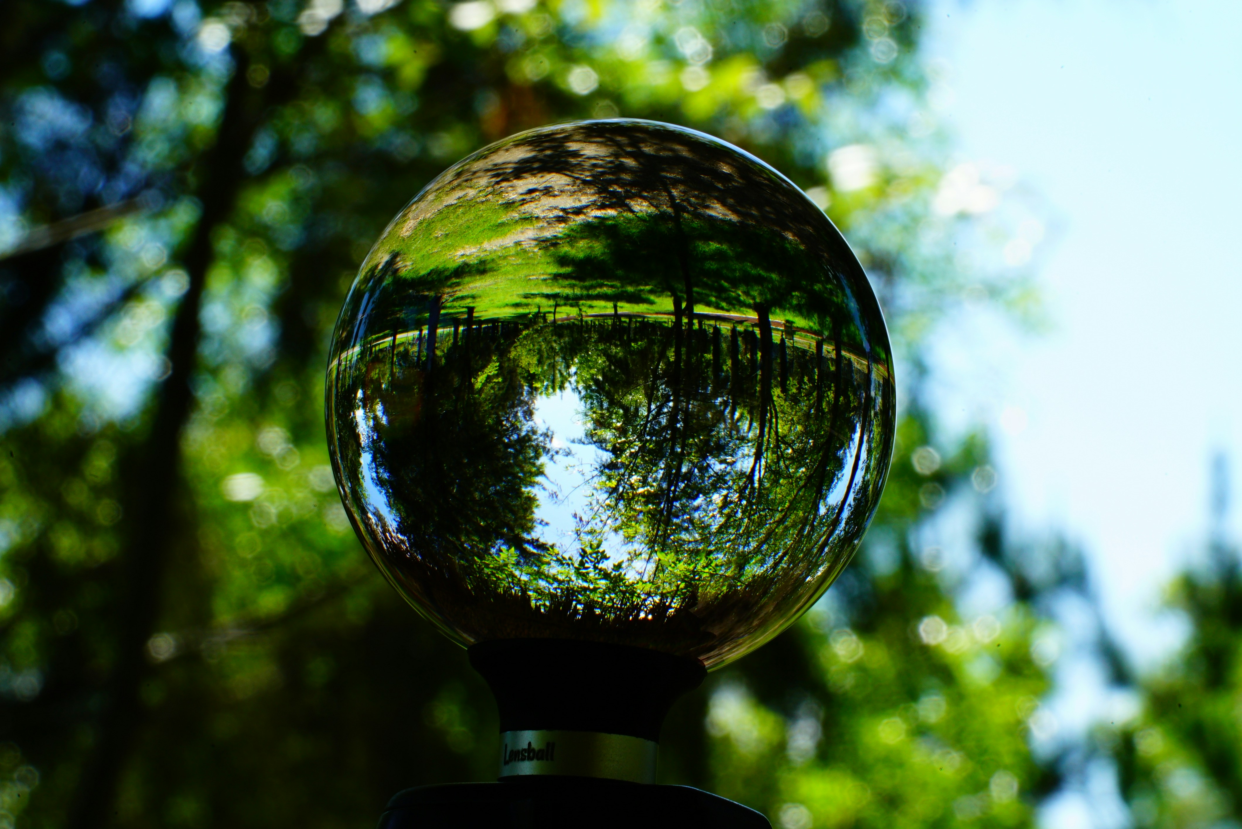 Polished Picture Jasper sphere with natural earth-tone landscape patterns