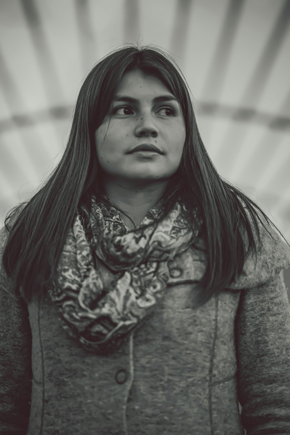 grayscale photo of woman wearing coat and scarf
