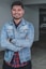 man wearing blue denim jacket smiling