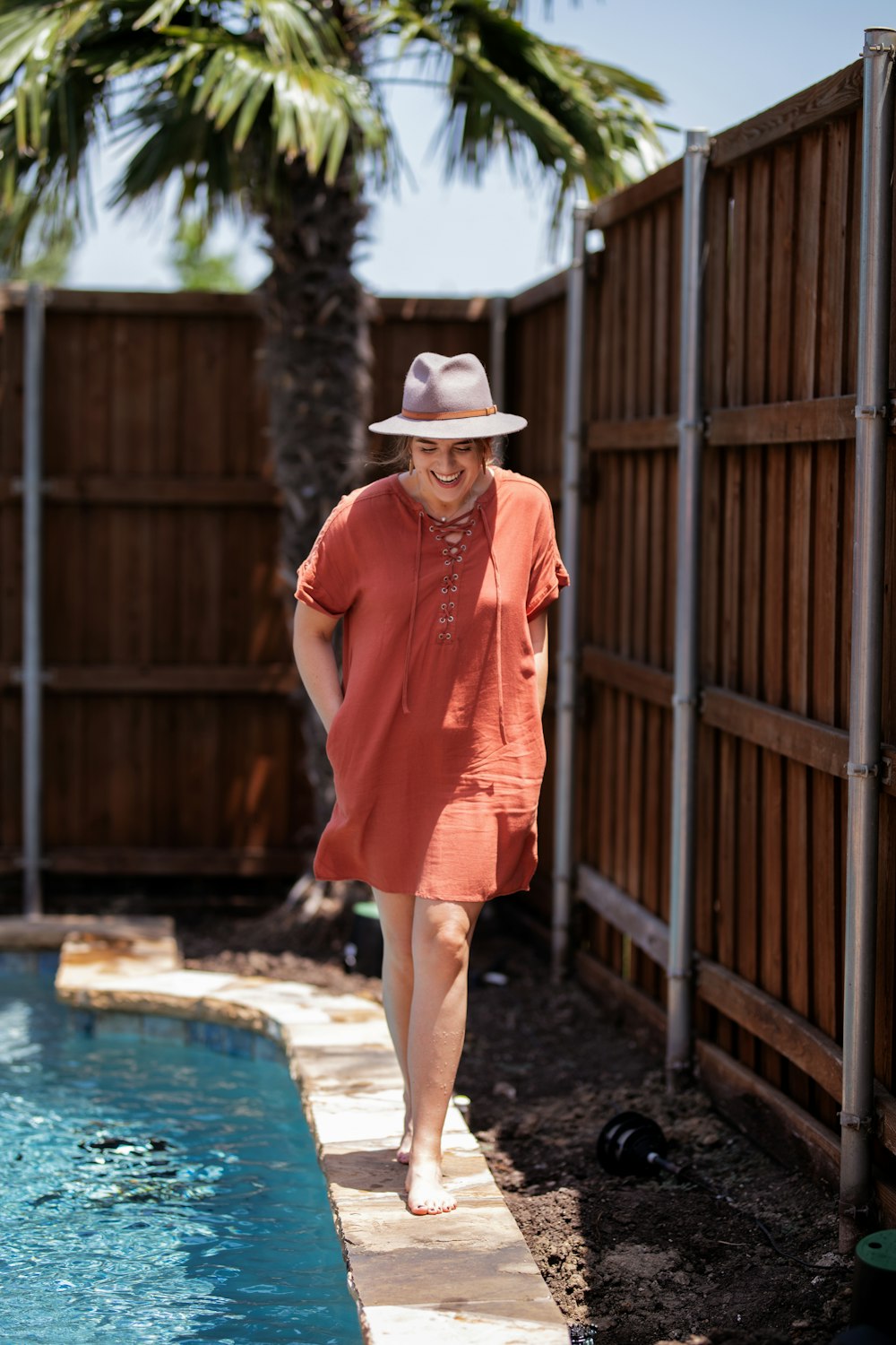 woman walking beside swimming pool