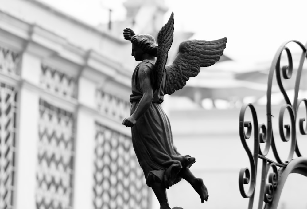 shallow focus photo of angel statue