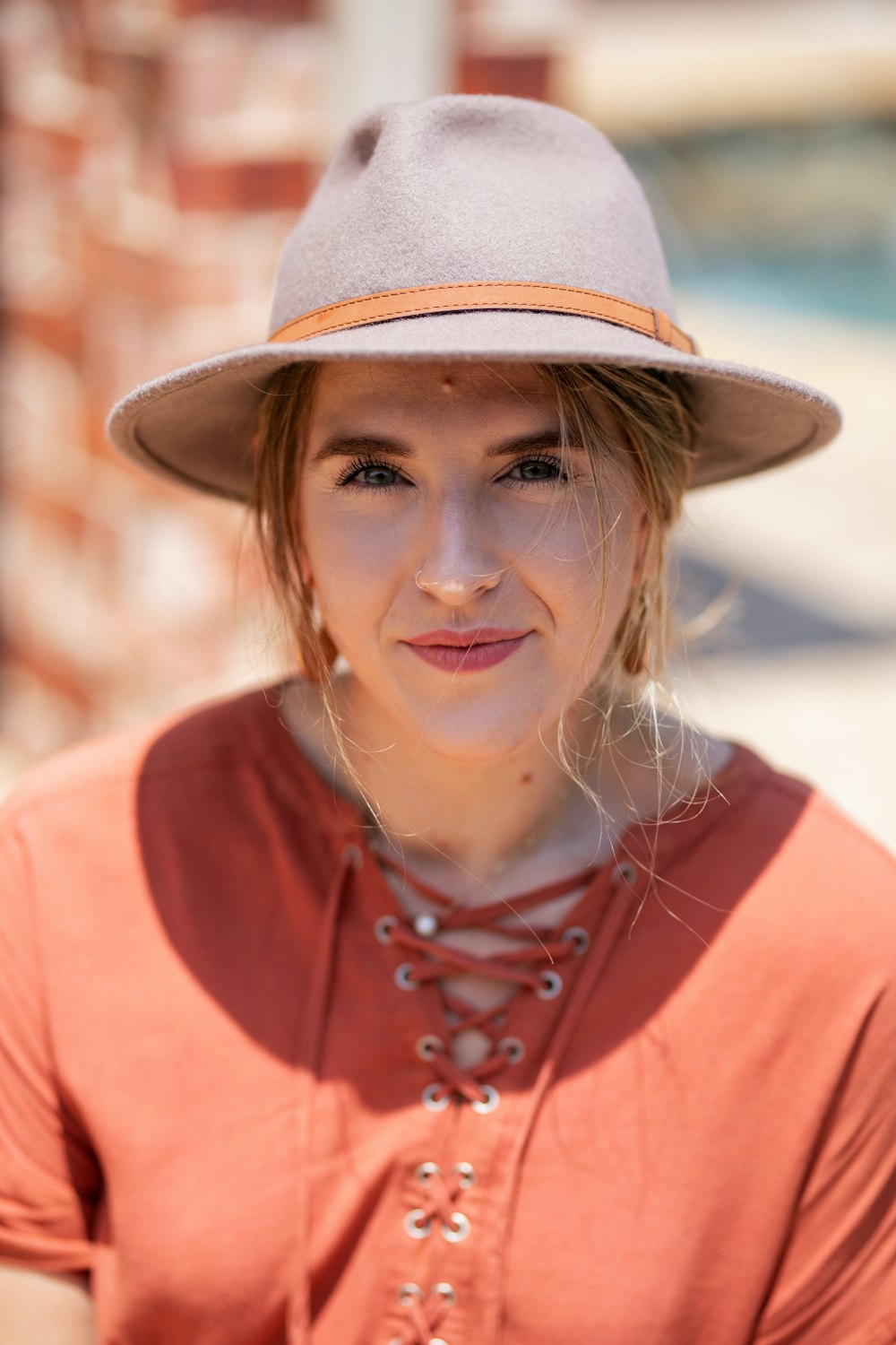 smiling woman wearing gray hat