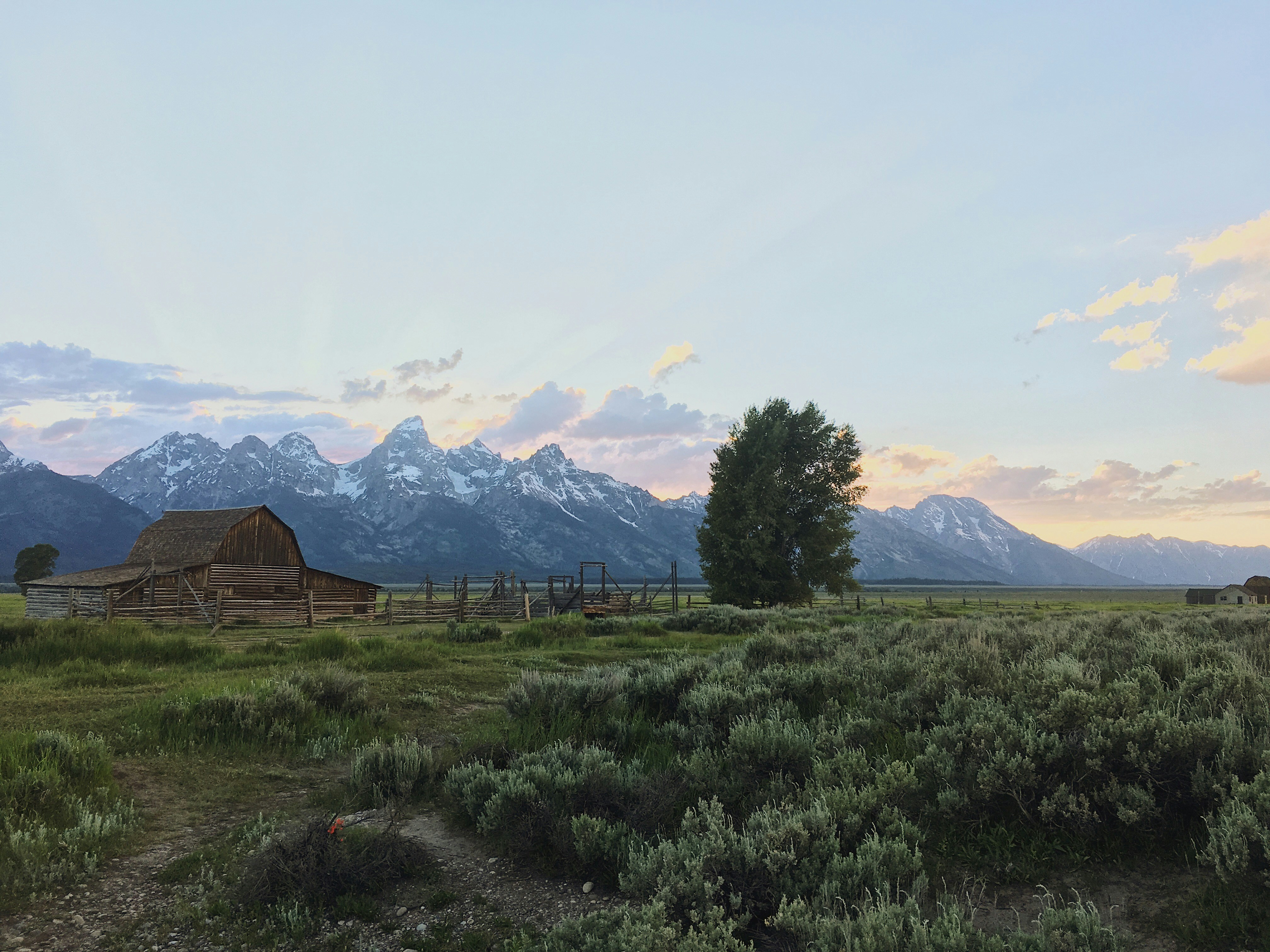 cabin near snow-covered mountain during daytime