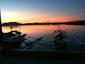 A stunning sunset over Madagascar's coastline with traditional boats.