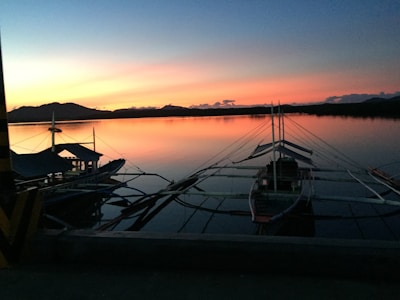 Sunset view over the turquoise waters of Diego Suarez bay with traditional pirogues floating gently.