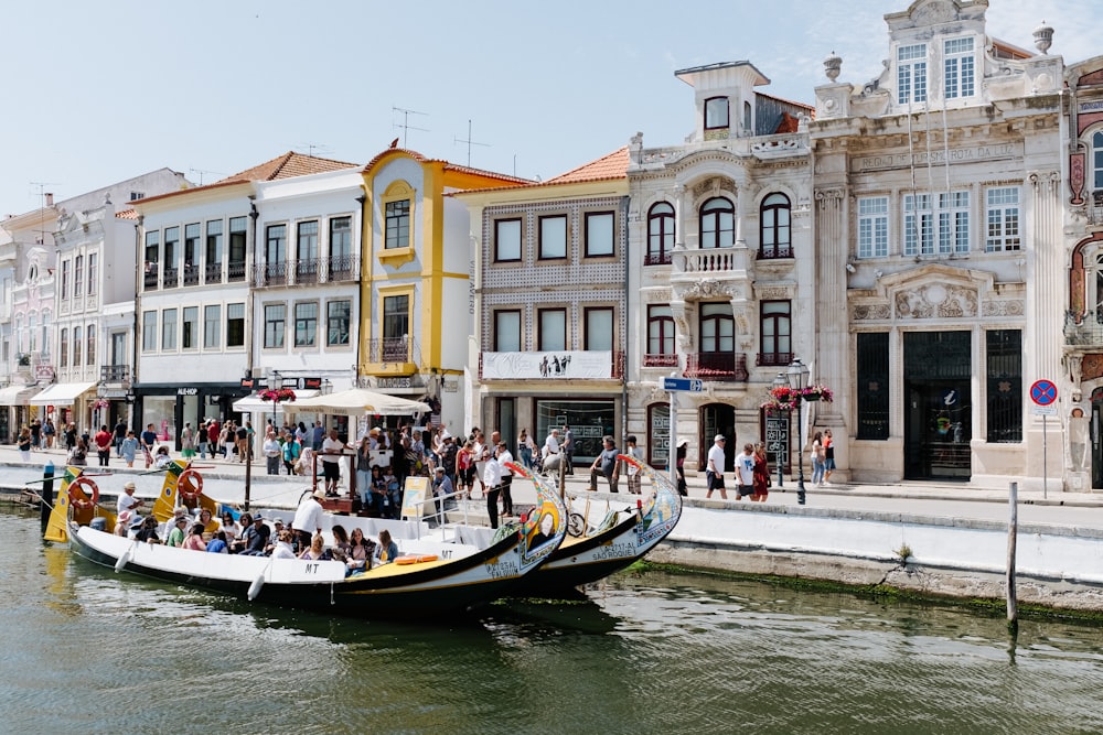 people in boat in front of buildings