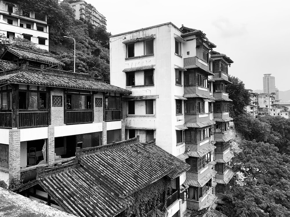 grayscale photo of buildings in slope of hill