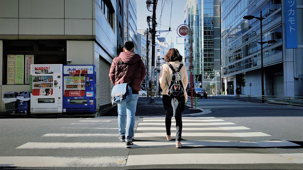 man and woman walking on street during daytime